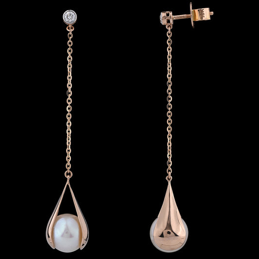 Elegant rose gold danglers featuring luminous pearls cradled in delicate teardrop cages, a timeless touch from jnjbymadhuri.
