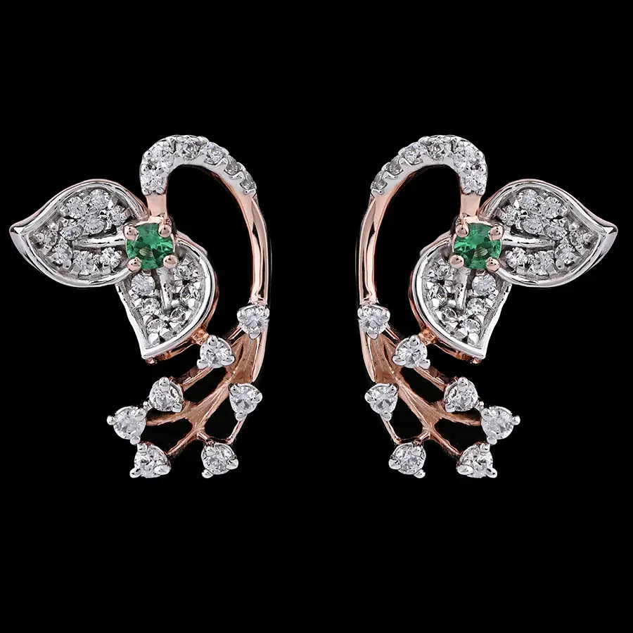 Stylish leaf-shaped earrings featuring dazzling white stones and a subtle green centerpiece, blending elegance with modern flair. Designed by jnjbymadhuri, these earrings add a graceful sparkle to any look.
