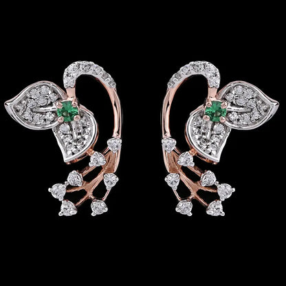 Stylish leaf-shaped earrings featuring dazzling white stones and a subtle green centerpiece, blending elegance with modern flair. Designed by jnjbymadhuri, these earrings add a graceful sparkle to any look.
