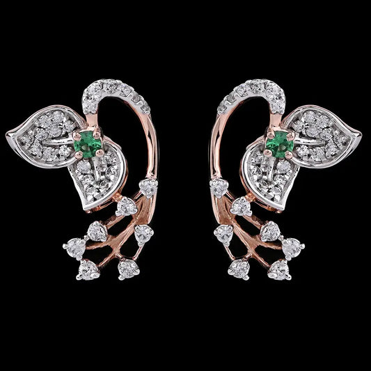 Stylish leaf-shaped earrings featuring dazzling white stones and a subtle green centerpiece, blending elegance with modern flair. Designed by jnjbymadhuri, these earrings add a graceful sparkle to any look.
