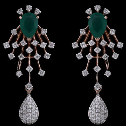 Exquisite earrings featuring emerald green stones, diamond-studded latticework, and teardrop danglers. A dazzling creation from jnjbymadhuri.
