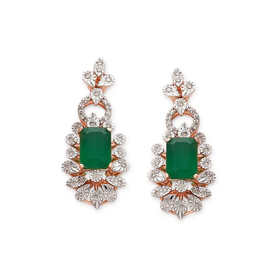 These earrings feature a classic drop design with a striking emerald green center stone, beautifully framed by a fan of sparkling white stones. A luxurious and regal creation by jnjbymadhuri, perfect for evening elegance.
