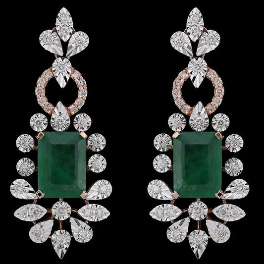 Elegant emerald and diamond drop earrings from jnjbymadhuri, featuring a rich green centerpiece surrounded by brilliant teardrop diamonds. A perfect blend of timeless charm and luxury craftsmanship by jnjbymadhuri.
