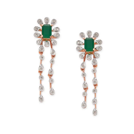 These earrings showcase a floral-inspired design with a rich green central gemstone surrounded by sparkling diamonds and elegant cascading diamond strands. A refined and artistic piece, likely part of jnjbymadhuri's statement collection.
