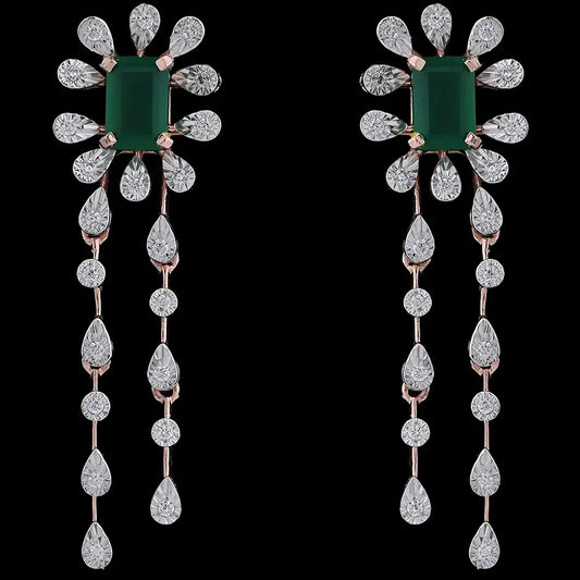 Elegant floral drop earrings featuring a central green gemstone surrounded by teardrop diamonds and twin cascading strands, set in rose gold. A luxurious statement piece by jnjbymadhuri.

