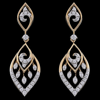 Graceful leaf-shaped earrings with gold curves and diamond-studded swirls, evoking timeless elegance. A luxurious creation by jnjbymadhuri.
