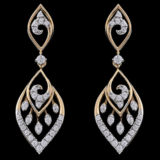 Graceful leaf-shaped earrings with gold curves and diamond-studded swirls, evoking timeless elegance. A luxurious creation by jnjbymadhuri.

