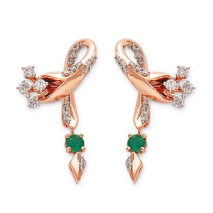 Rose gold earrings featuring a flowing ribbon-like design adorned with diamonds and emerald green drops, a refined creation by jnjbymadhuri.
