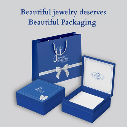 Elegant blue jewelry packaging from jnjbymadhuri, featuring a gift bag, a closed box, and an open box with white interior, accompanied by the tagline "Beautiful jewelry deserves Beautiful Packaging" on a light gray background.
