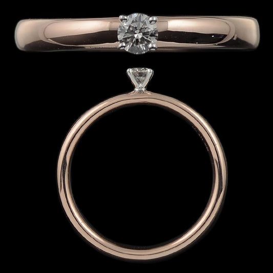 A sleek rose gold ring featuring a sparkling round diamond in a prong setting, exuding refined elegance. This timeless piece by jnjbymadhuri blends simplicity with sophistication.
