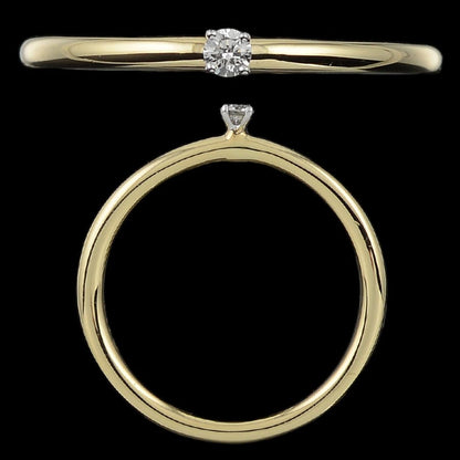 "Minimalist jnjbymadhuri gold ring with a single round diamond solitaire, displayed from top and side views against a black background."
