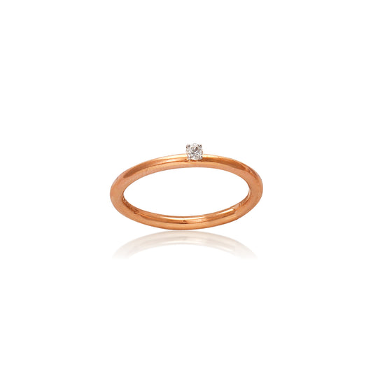 "Minimalist rose gold solitaire ring by jnjbymadhuri featuring a single round diamond on a white background."
