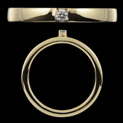 Bold and elegant, this gold band ring features a centrally set diamond with a polished finish for modern sophistication. A timeless design by jnjbymadhuri.
