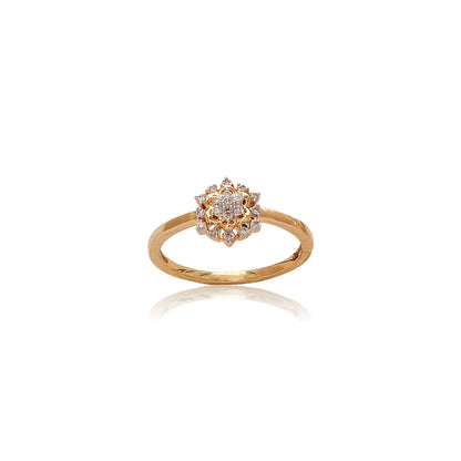 Delicate gold ring by jnjbymadhuri featuring a floral-inspired cluster of round-cut diamonds set in a symmetrical bloom pattern, showcased on a clean white background.
