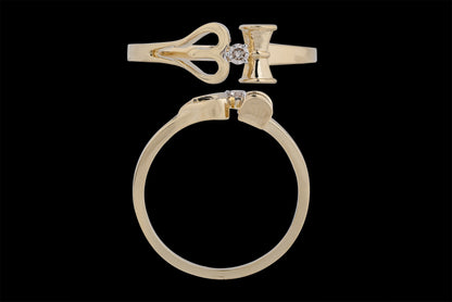 This is another view of the same distinctive gold ring, reinforcing its key design elements: the heart-shaped motif, vertical bar, and central diamond. The top-down and side angles clearly showcase the precision of the cut and symmetry, underlining its elegant yet symbolic appeal—an excellent representation of jnjbymadhuri's craftsmanship.
