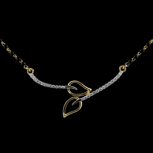 Elegant twin-leaf mangalsutra by jnjbymadhuri, featuring a delicate gold and silver-toned leaf motif at the center, set on a traditional black beaded chain, displayed against a classic black background for a striking contrast.

