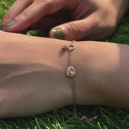 An elegant rose gold bracelet by jnjbymadhuri beautifully displayed on the wrist, featuring a unique heart-shaped charm and fine chain detail, adding a delicate touch of luxury to any look.
