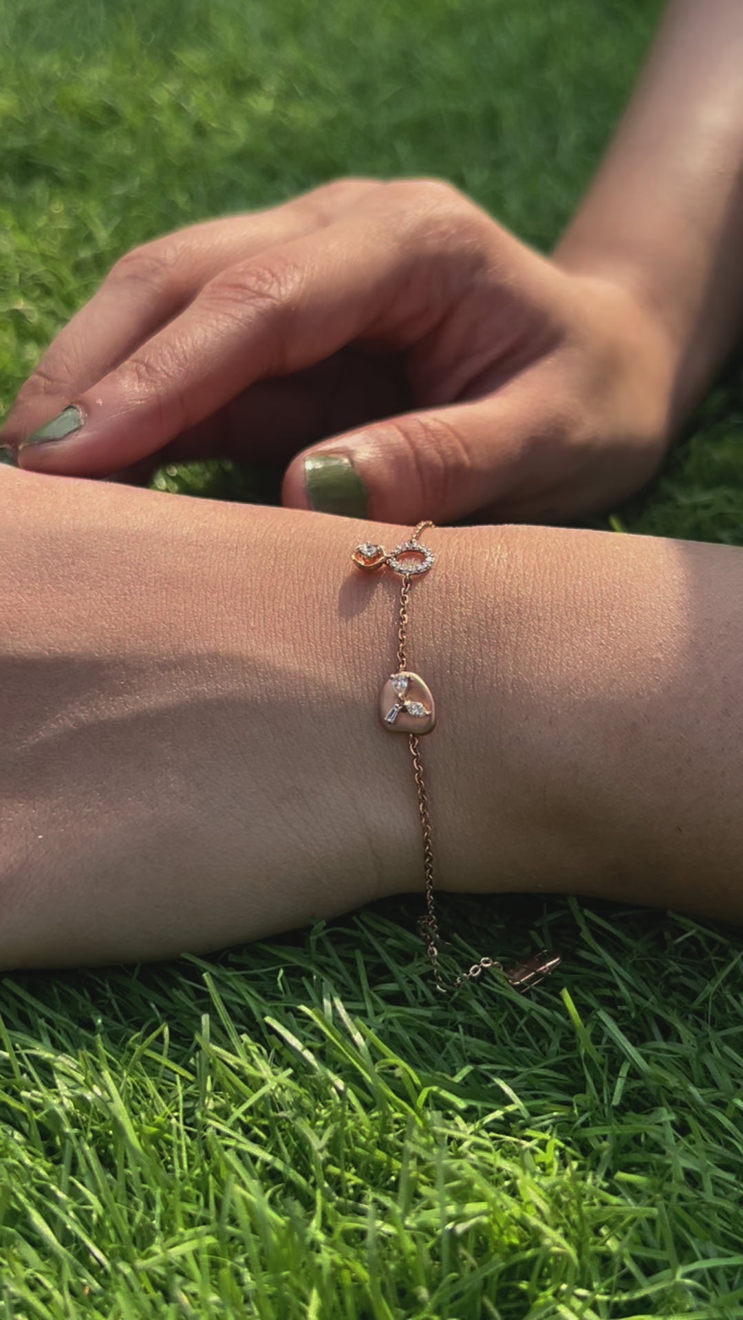 An elegant rose gold bracelet by jnjbymadhuri beautifully displayed on the wrist, featuring a unique heart-shaped charm and fine chain detail, adding a delicate touch of luxury to any look.
