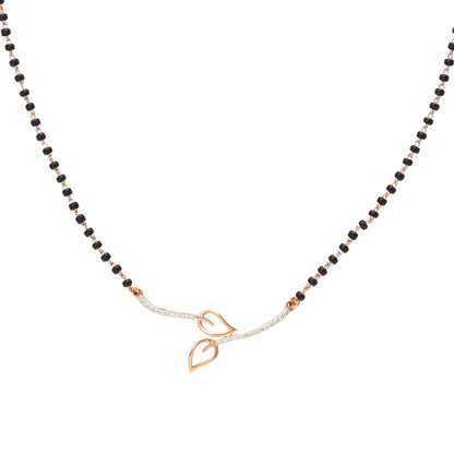 Minimalist mangalsutra by jnjbymadhuri featuring a sleek black beaded chain with a contemporary double-leaf motif in gold at the center, perfectly balancing tradition with modern elegance.
