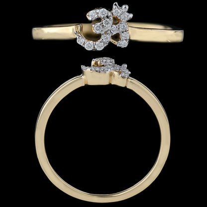 A stunning gold ring featuring a diamond-studded Om symbol design is captured against a solid black background, emphasizing its spiritual elegance and intricate craftsmanship, beautifully representing the essence of jnjbymadhuri.
